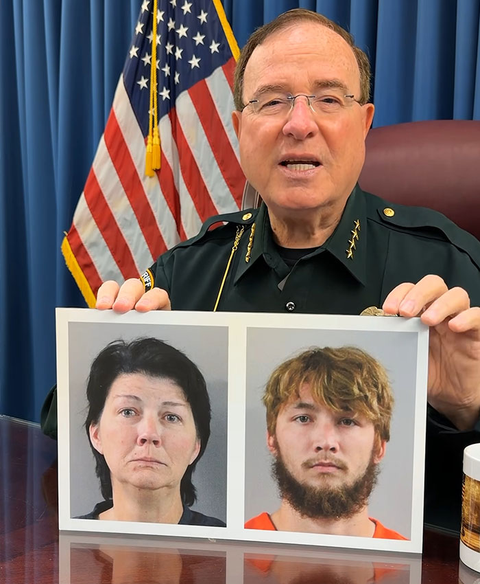 A sheriff holding up mugshots of the mother and son charged after a damning confession to police.