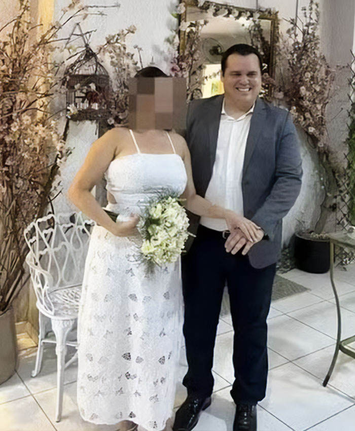 A man in a suit standing next to a bride with a blurred face representing a daughter dating her boss A man in a suit standing next to a bride with a blurred face representing a daughter dating her boss