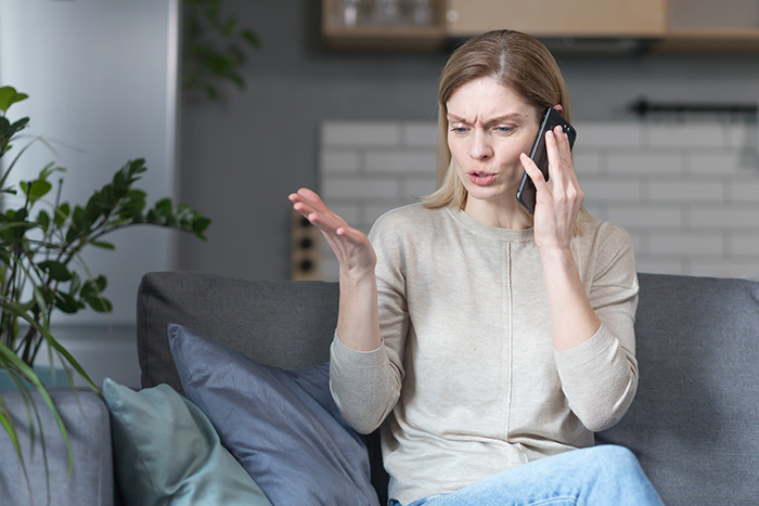 Woman on phone with frustrated expression about 17YO trying to scare off Dads girlfriend. Woman on phone with frustrated expression about 17YO trying to scare off Dads girlfriend.