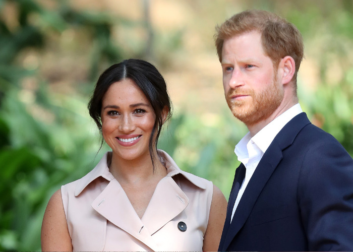 Prince Harry and Meghan smiling, looking ahead, showcasing their unified front despite reports about King Charles letter. Prince Harry and Meghan smiling, looking ahead, showcasing their unified front despite reports about King Charles letter.
