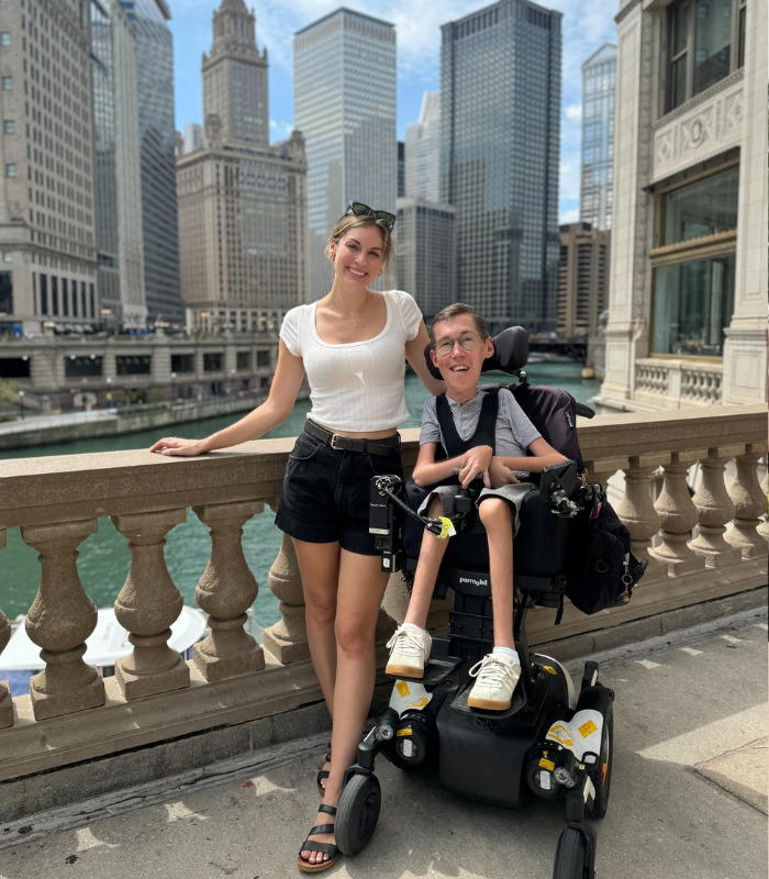 TikTok stars, a happy couple, posing on a city bridge with skyscrapers, sharing their journey towards pregnancy. TikTok stars, a happy couple, posing on a city bridge with skyscrapers, sharing their journey towards pregnancy.