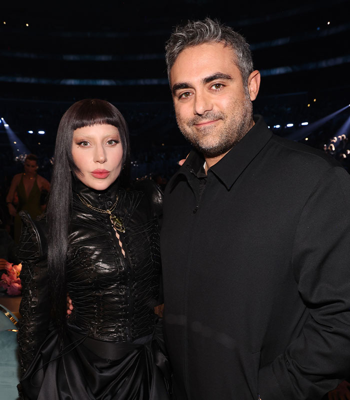 Lady Gaga and Michael Polansky facing criticism for their baby girl name choice, posing together at an event.