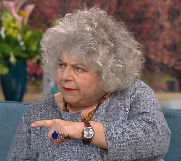 Harry Potter star Miriam Margolyes pointing, with gray curly hair, after her appalling remark about skin. Harry Potter star Miriam Margolyes pointing, with gray curly hair, after her appalling remark about skin.