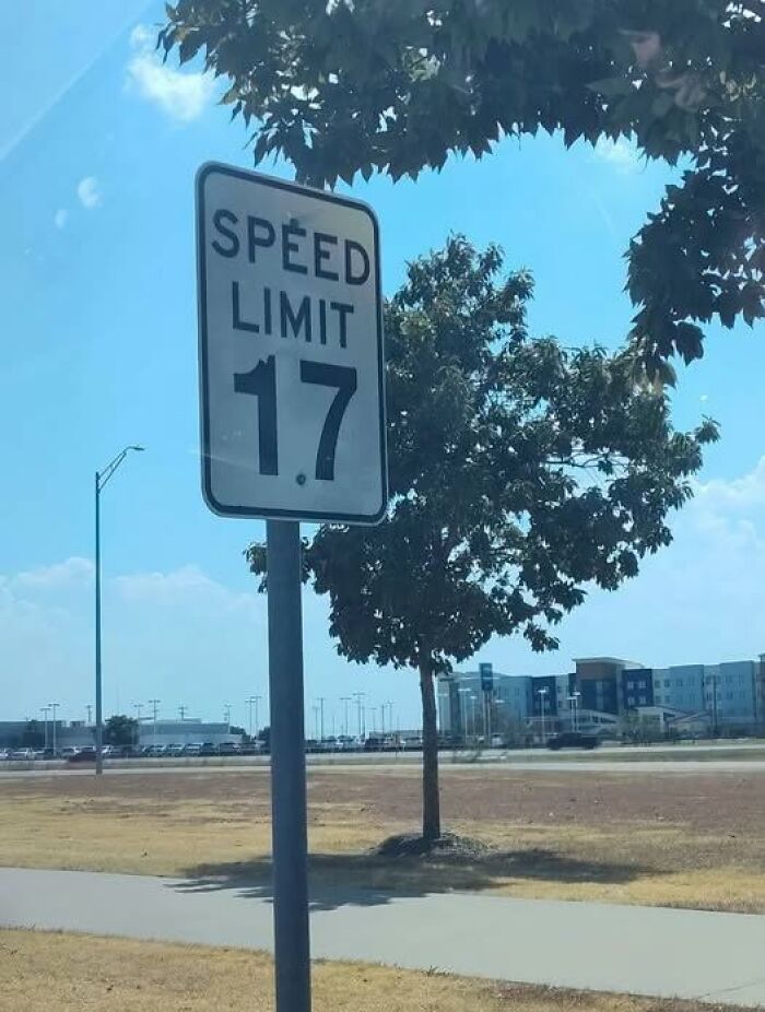A road sign displaying a funny signs speed limit of 17 mph.