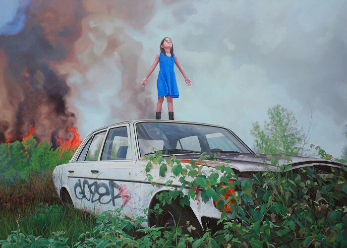 A girl stands on a ruined car as fire burns in a dystopian painting by Kevin Peterson