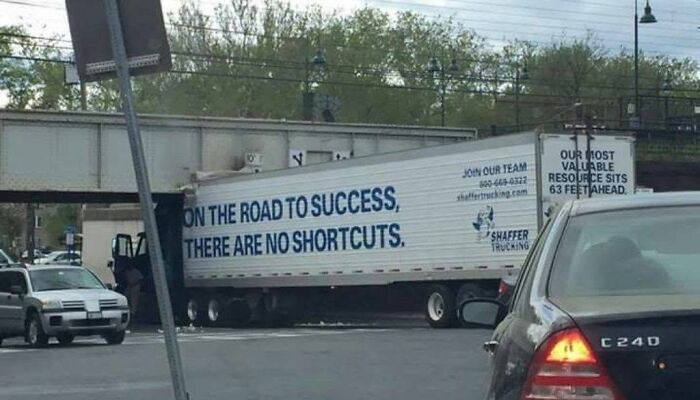 Truck blocking road with humorous success and no shortcuts message