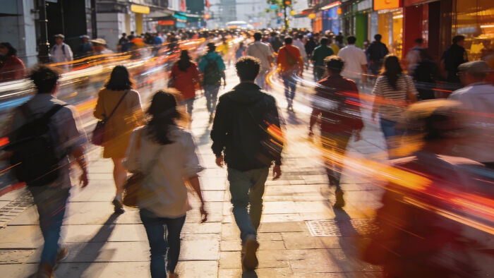 Blurry crowd walking on a city street, representing future problems society might face.