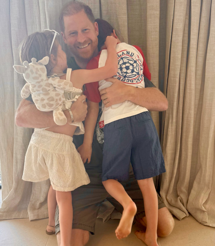 Prince Harry smiles, hugging his children, sparking tension with his UK return. Prince Harry smiles, hugging his children, sparking tension with his UK return.