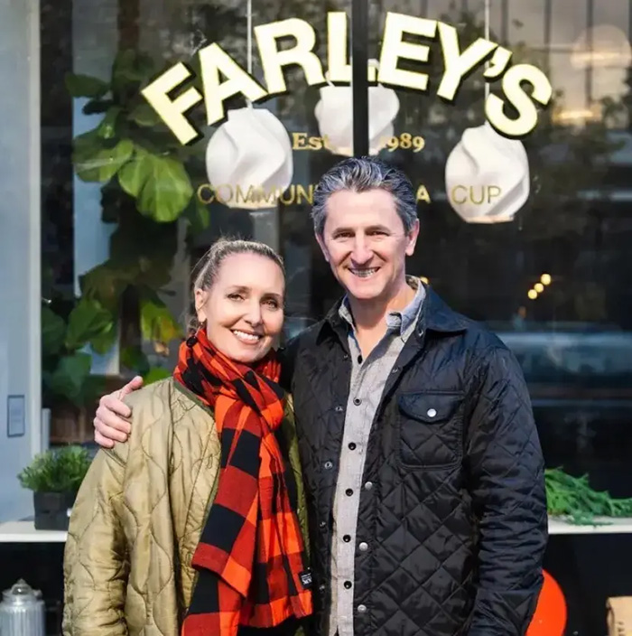 Husband and wife stand together outside Farley's cafe during missing wife search