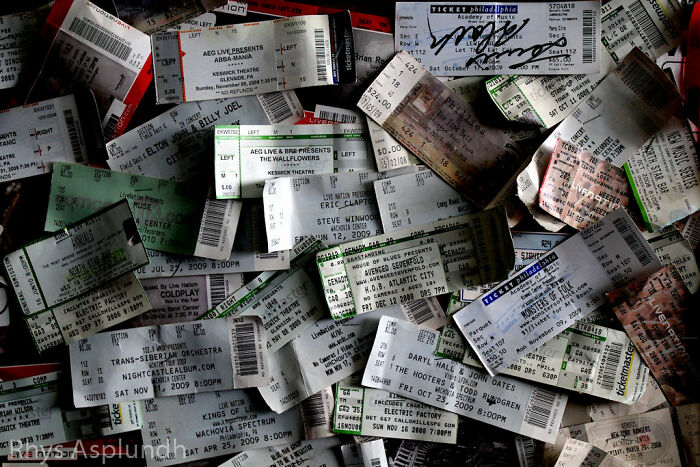 A pile of various concert and event tickets, representing simple joys from past experiences.