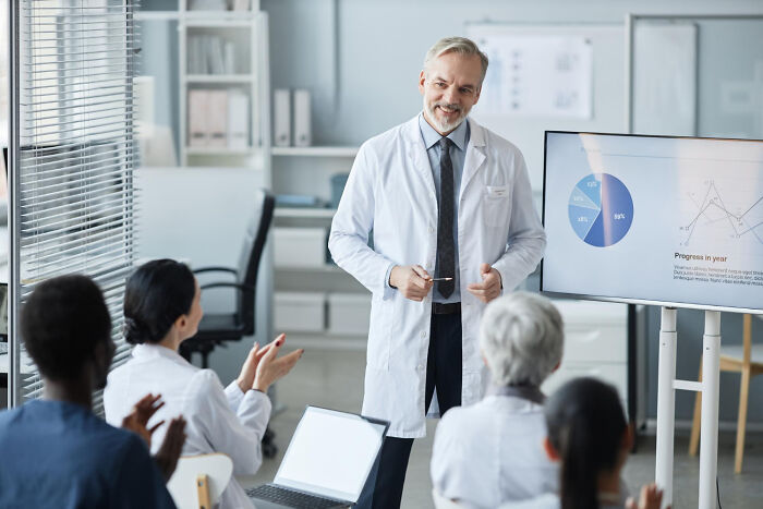 A male doctor giving a presentation about historical medical practices