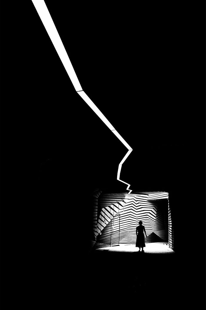 Everyday architecture transforms into a bold minimalist scene with stark light and shadow.
