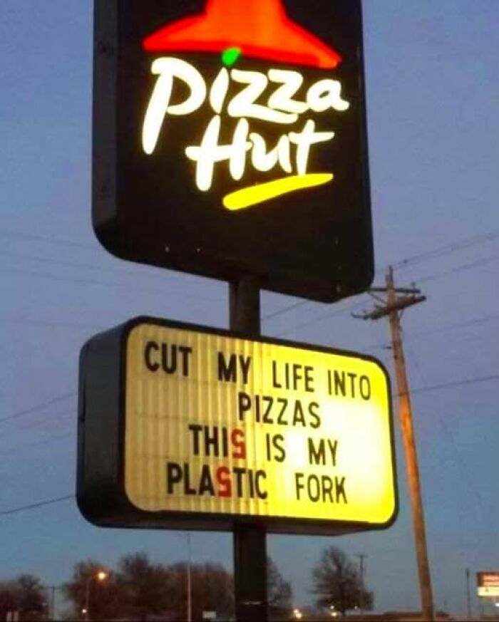 A funny Pizza Hut sign with silly lyrics: Cut my life into pizzas, this is my plastic fork.