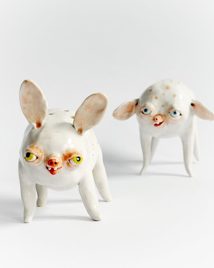 Two funny-looking four-legged weird ceramic sculptures designed as home decor