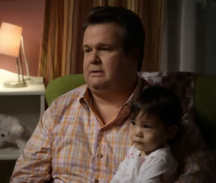 Modern Family reunion pic of Cameron holding Lily, a major figure absent from some fan recognition.