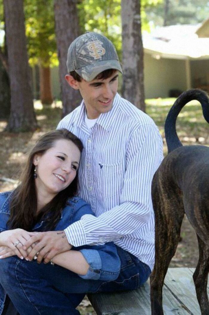 Unhinged image of a couple with a dog looking like a horse's rear.