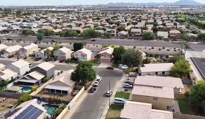 An aerial view of a neighborhood, highlighting the context of a $450K home seized by HOA.