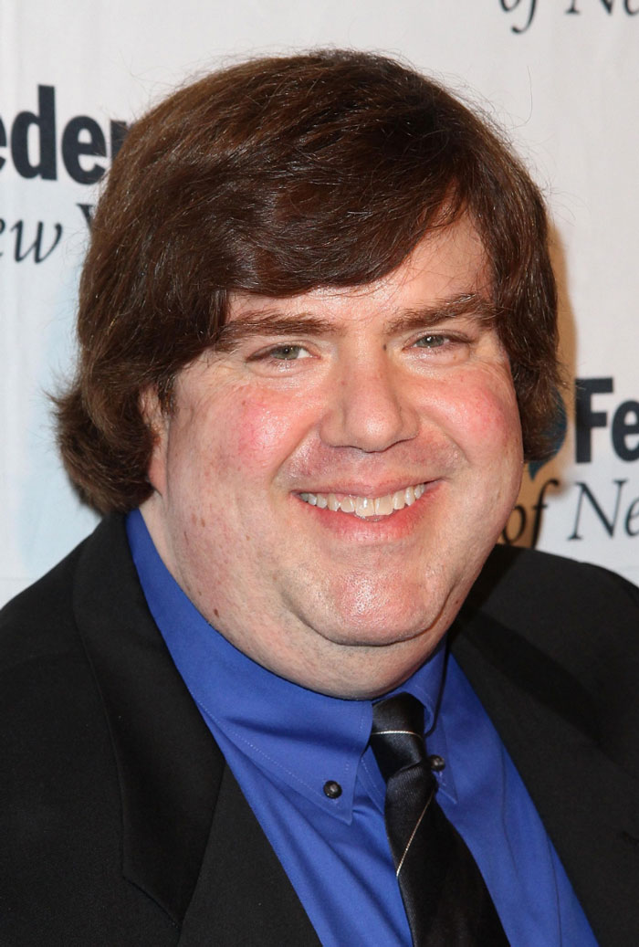 Chris Farley smiling, a famous face revealing Hollywood secrets.