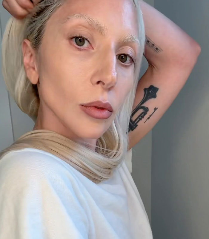 Lady Gaga looking directly at the camera, facing criticism over her baby girl's name.