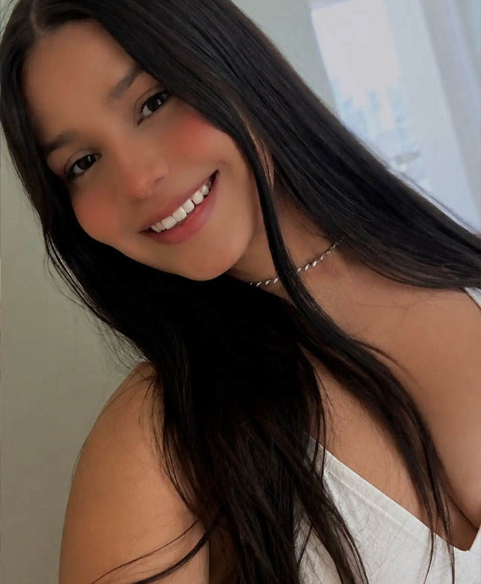 A smiling 22yo daughter with long dark hair representing a mother agreed to her daughter dating her boss A smiling 22yo daughter with long dark hair representing a mother agreed to her daughter dating her boss