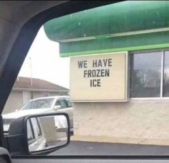 A funny sign on a drive-thru window stating We Have Frozen Ice.