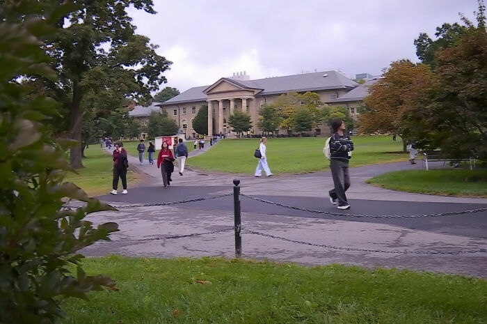 Students walking on campus lawn near academic buildings, related to the Cornell 7 group chat case Students walking on campus lawn near academic buildings, related to the Cornell 7 group chat case