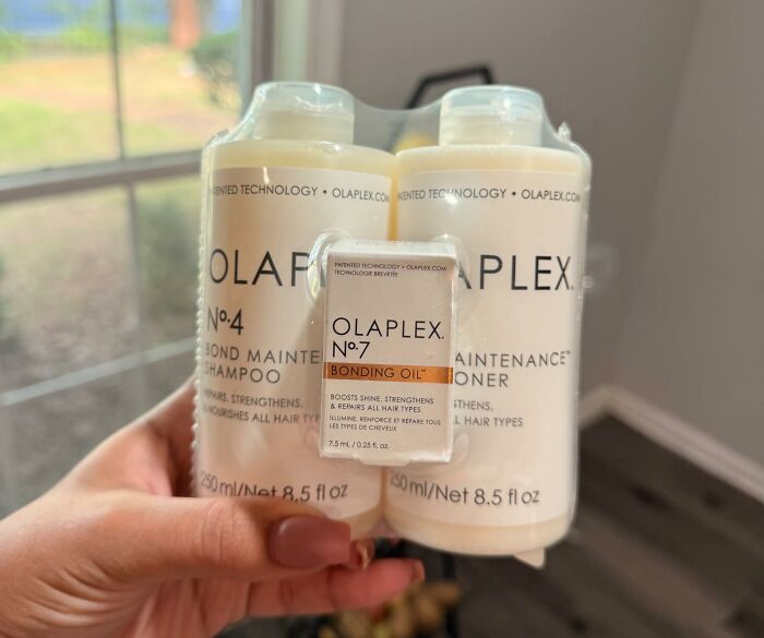 A hand holding a packaged Olaplex hair care set, an exclusive pick from Prime Big Deal Days