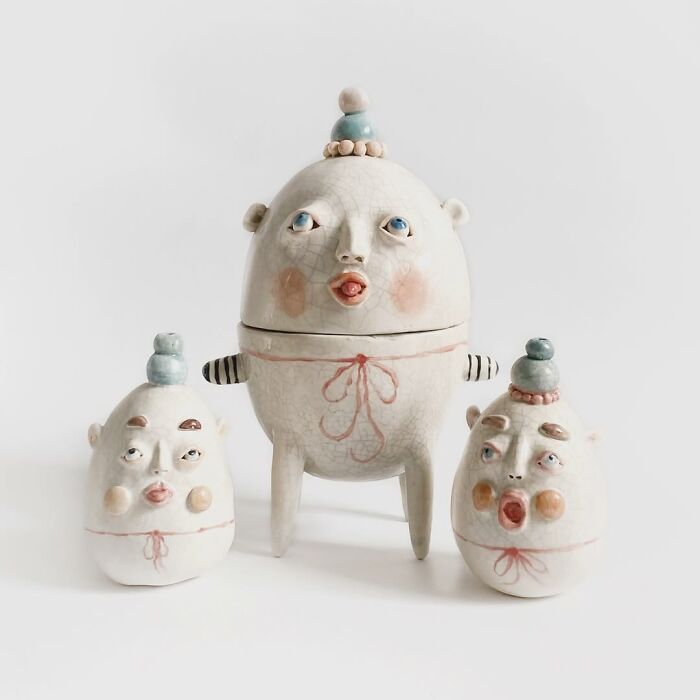 Three weird ceramic sculptures of round humpty-dumpty faces that double as home decor
