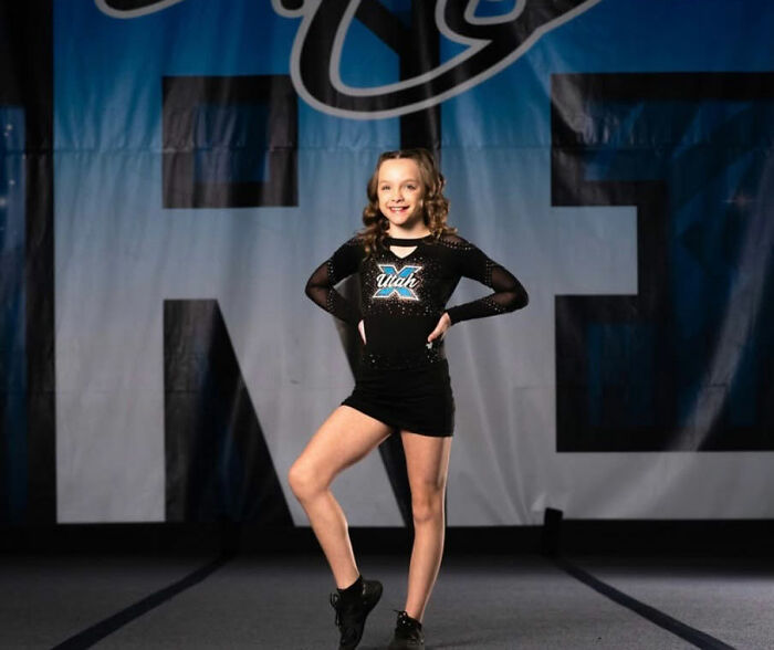 A young girl in a black cheerleading uniform, posing, related to the Las Vegas hotel case. A young girl in a black cheerleading uniform, posing, related to the Las Vegas hotel case.