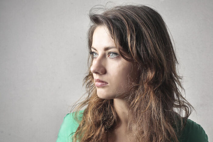 A woman looking sideways, reflecting on weirdest body changes in her 30s and 40s