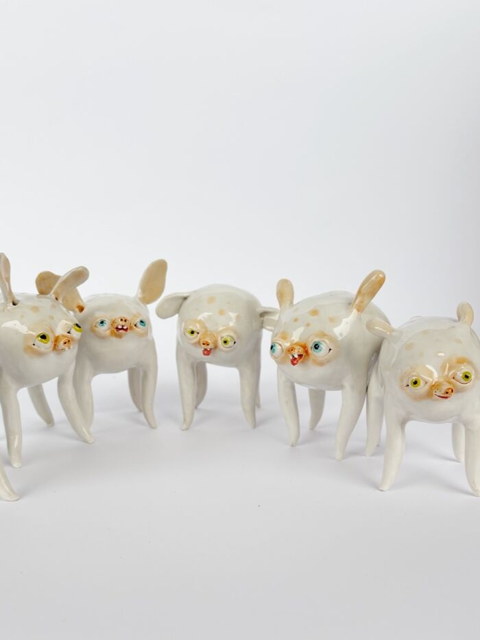 A group of five small, multi-eyed creature figurines made of weird ceramic sculptures for home decor.