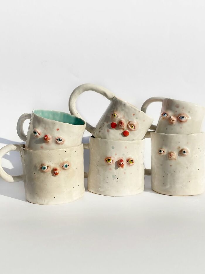 A stack of quirky ceramic mugs featuring unusual faces as home decor pieces.