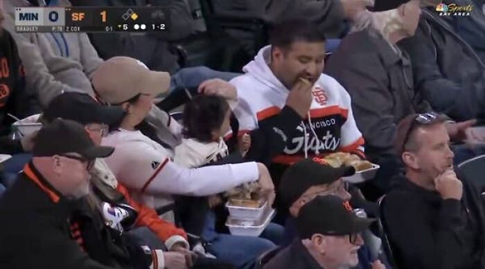 Mom and husband enjoying Giants game with baby and food