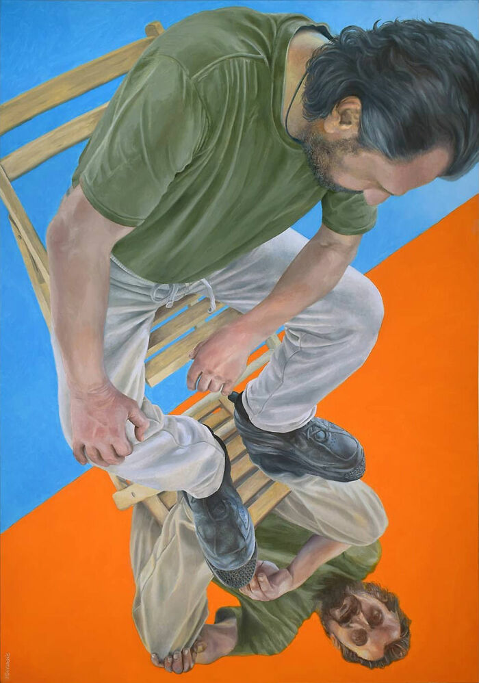 Man on chair in a Michel Devanakis artwork using extreme perspective to view the human form.