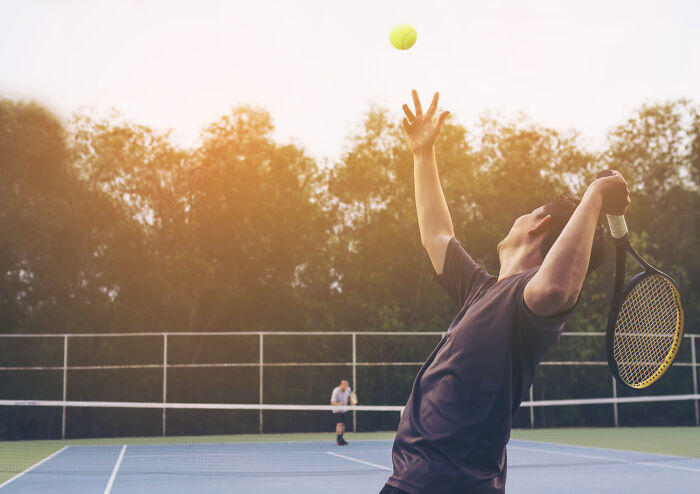 A tennis player serving a ball, representing unexpected outcomes in court arguments.