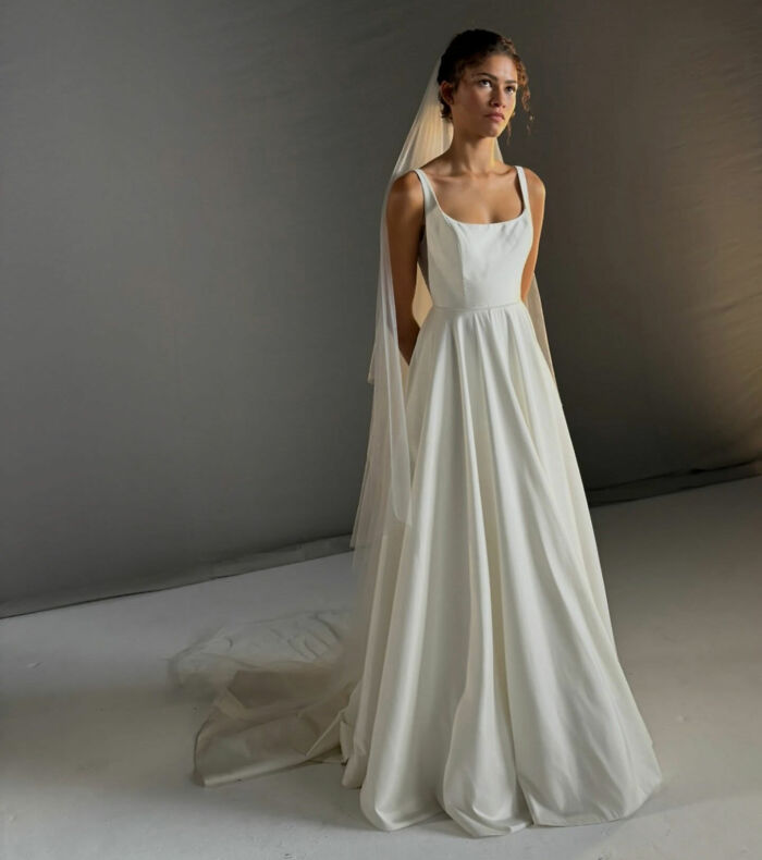 Zendaya poses in a white, floor-length custom wedding dress with a long veil, looking elegant. Zendaya poses in a white, floor-length custom wedding dress with a long veil, looking elegant.