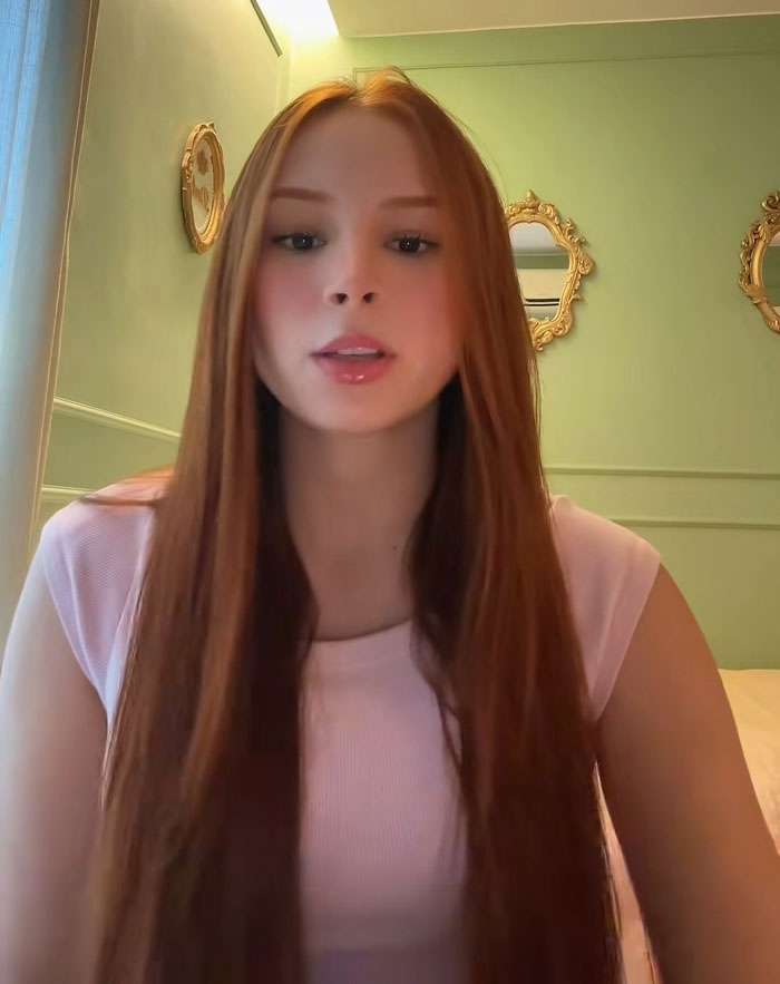 A close-up of a young influencer speaking about her severe pain after surgery