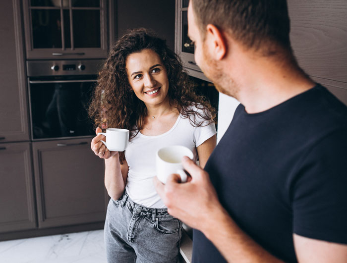 A woman and a man holding mugs in the kitchen, referencing the sister who gives brother part of her liver A woman and a man holding mugs in the kitchen, referencing the sister who gives brother part of her liver