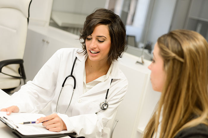 A female doctor consults with a patient, discussing potential side effects of viral Ashwagandha gummies like liver failure.