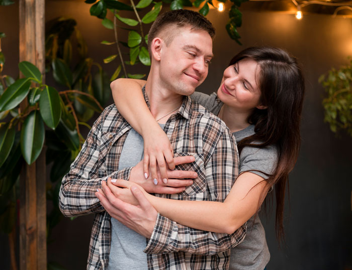 A loving sister hugging her brother from behind, reflecting a deep bond after a difficult journey A loving sister hugging her brother from behind, reflecting a deep bond after a difficult journey