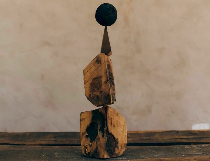 Heather Chontos creative art sculpture of stacked wooden blocks with a dark spherical top.