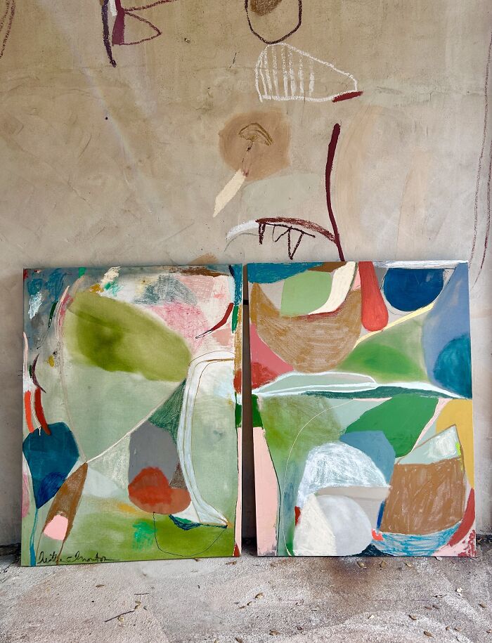 Two complementary abstract Creative Art canvases by Heather Chontos, featuring harmonious colors and fluid forms displayed on a wall.