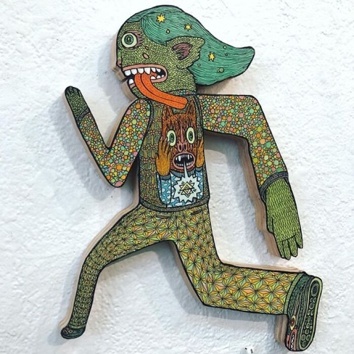 Theo Ellsworth wooden figure in running pose with detailed patterns