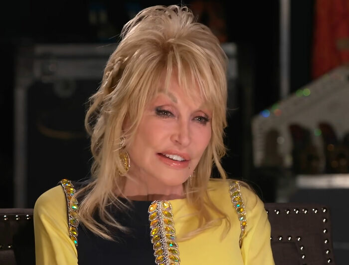 Close-up portrait of Dolly Parton smiling during an interview Close-up portrait of Dolly Parton smiling during an interview