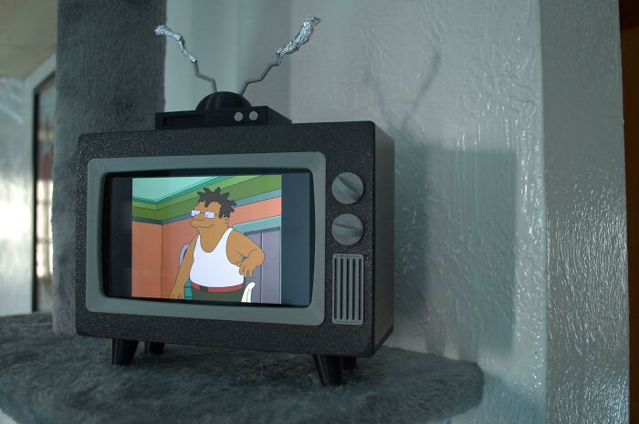 A retro-style miniature TV playing a cartoon, a brilliant piece made with 3D printers.