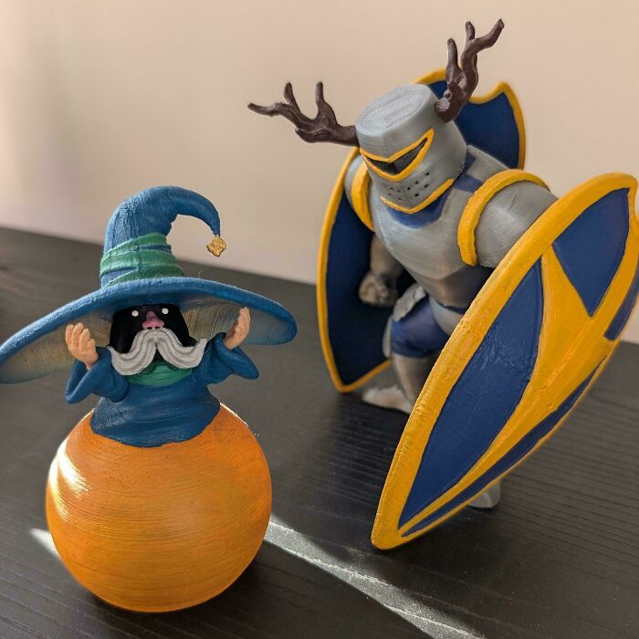 Two colorful 3D printed fantasy figurines, a wizard and a knight, showcasing brilliant stuff from 3D printers.