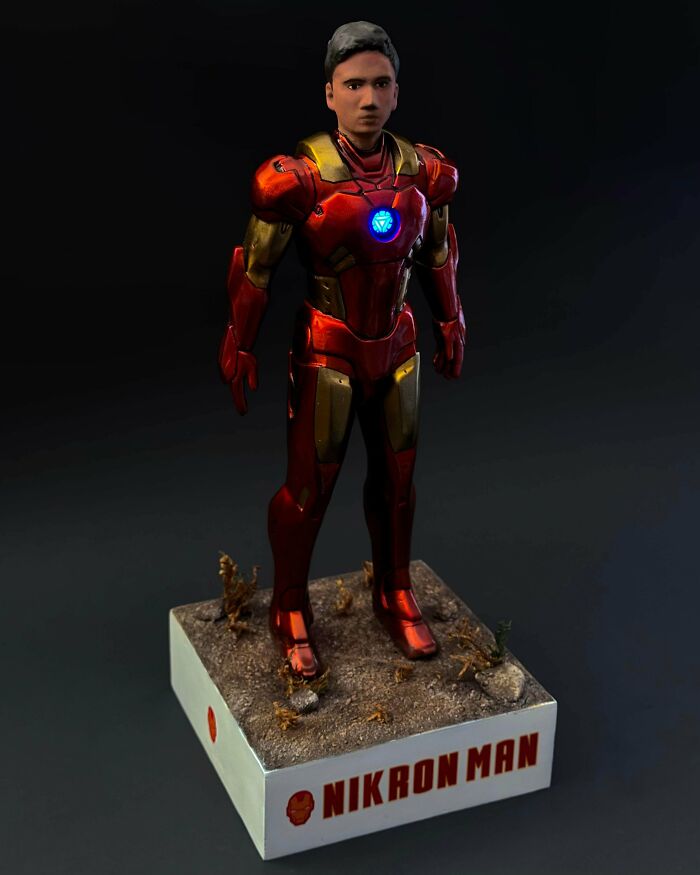 A full-body Iron Man action figure with a glowing chest reactor, demonstrating brilliant stuff from 3D printers.