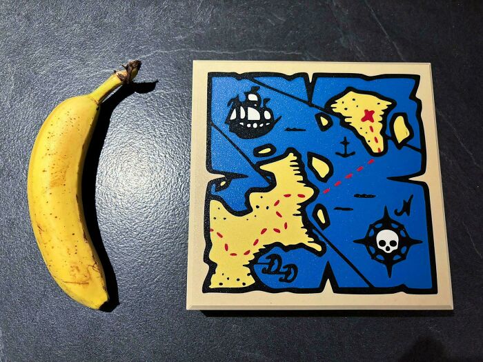 3D printed pirate treasure map next to a banana for scale, a brilliant creation.