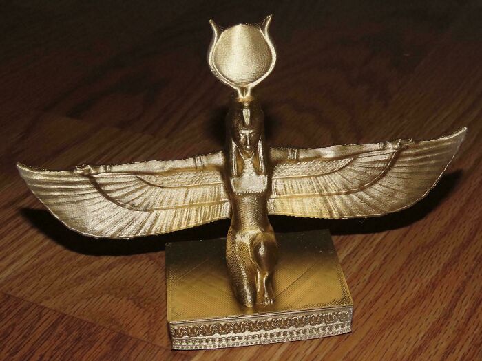 Golden 3D printed statue of a winged goddess, a brilliant creation.