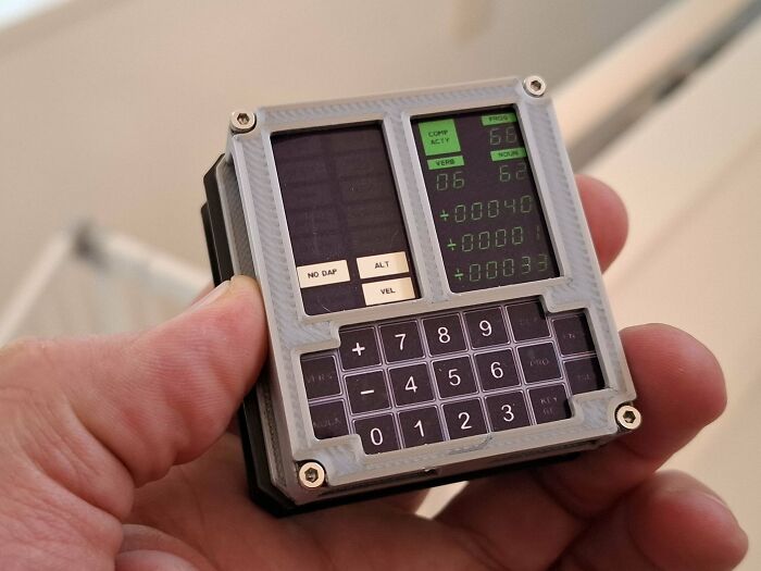 A hand holding a 3D printed calculator-like device, showcasing brilliant stuff created with 3D printers.
